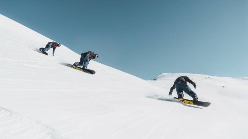 three person riding on snowboard | skiing
