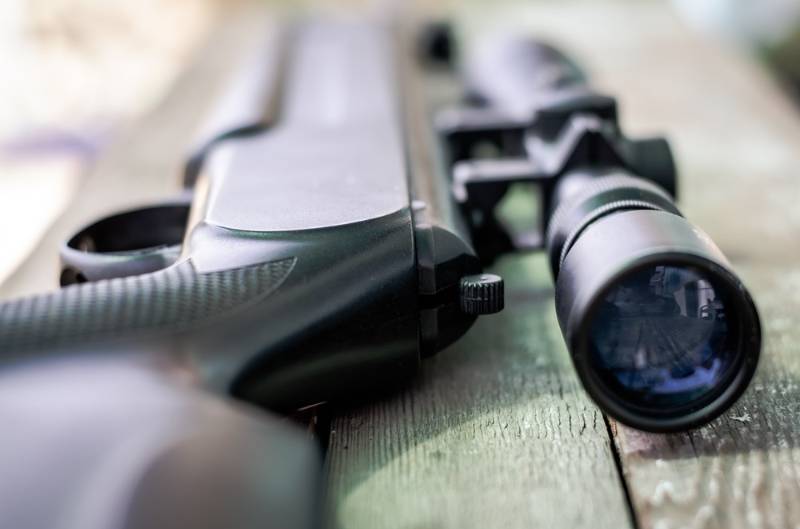 sniper-rifle-lies-on-wooden-background | best predator rifle
