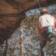 man in white tank top and blue denim jeans climbing on brown | Stay Safe: Why You Should Bother With Rock Climbing Insurance | Featured