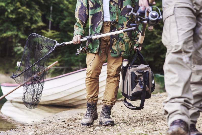 men-walking-carrying-fishing-tackle | lake fishing gear