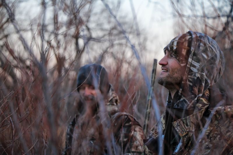 two mens inside forest | what license do you need to hunt coyotes