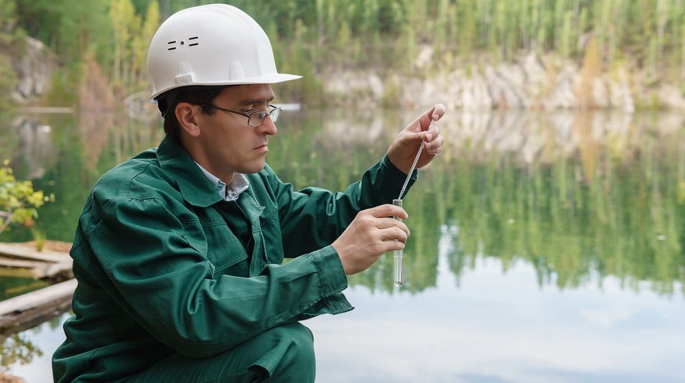 industrial-ecologist-or-chemist-takes-a-sample-of-water-from-lake-at-the-site-of-a-flooded-mining-pit | Non-Potable Water | Types and How to Spot Them | featured