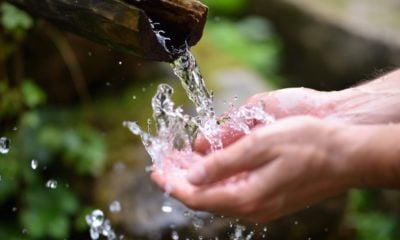 man-washing-hands-in-fresh-cold-potable-water-of-mountain-spring | How to Have Potable Water Anywhere | featured