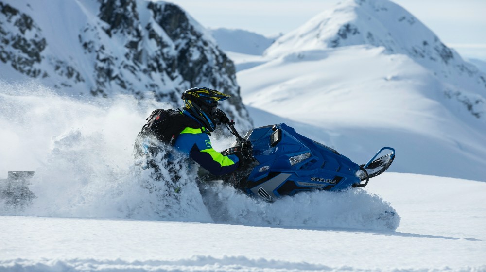 Person Riding on Snowmobile | Snowmobiling | Featured