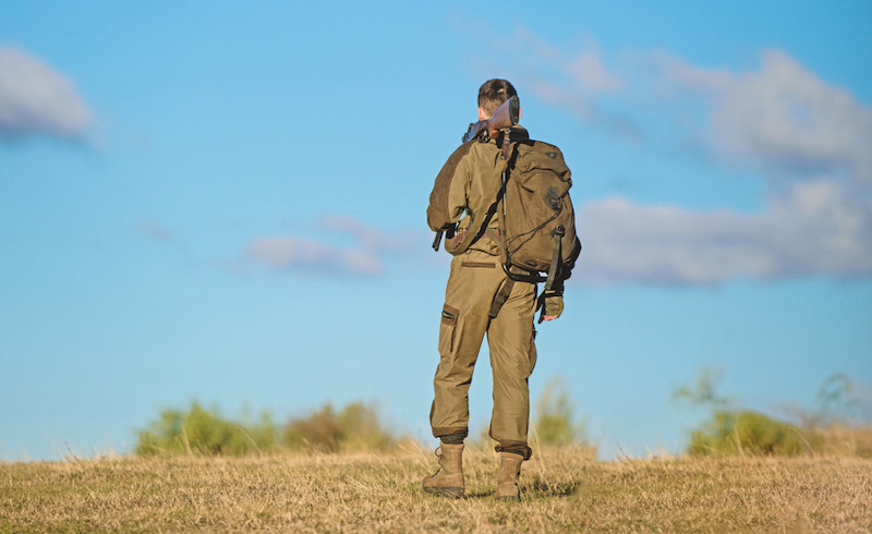 Man-hunter-carry-rifle-blue-sky-background | crow hunter