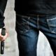 killer-holding-gun-side-him-robbery | Beretta 21A Bobcat | Gun Carrier Handgun Review | Featured