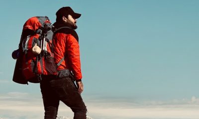 man standing on cliff edge | Ultimate Backpacking Checklist for Beginners | featured