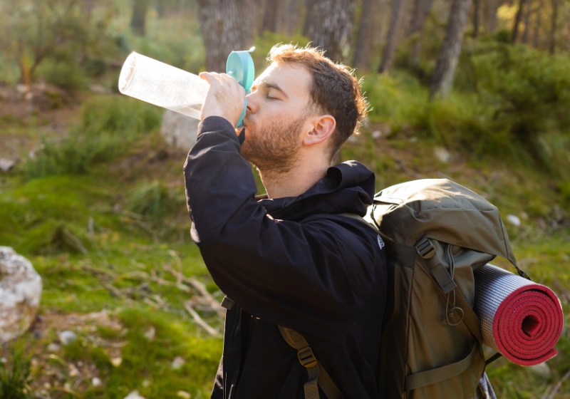 young male hiker drinking water his | non potable water