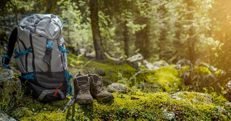 Backpack and hiking boots in forest-hiking shoes-ss