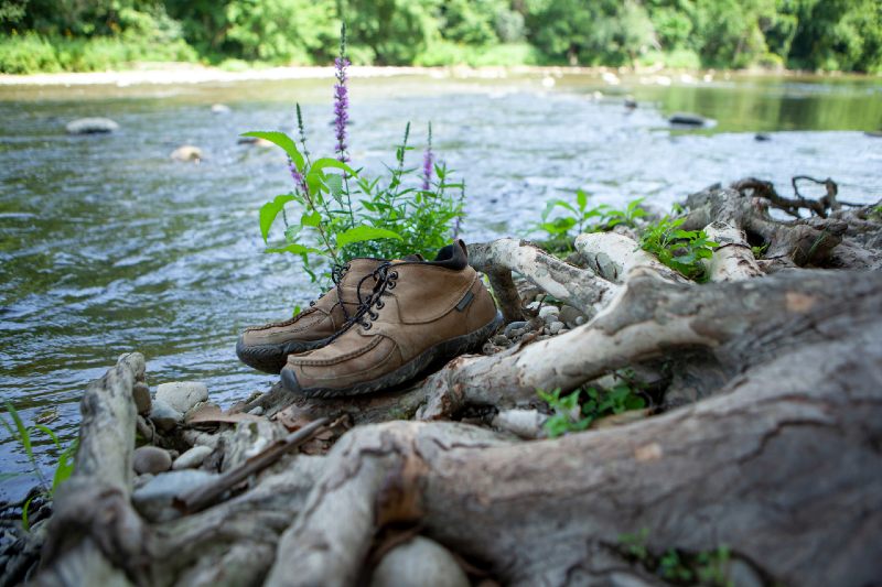 Pair of Hiking Shoes Boots by the River Hiking Bare Feet on a sunny Summer Day resting feet in the Water-hiking boot-ss