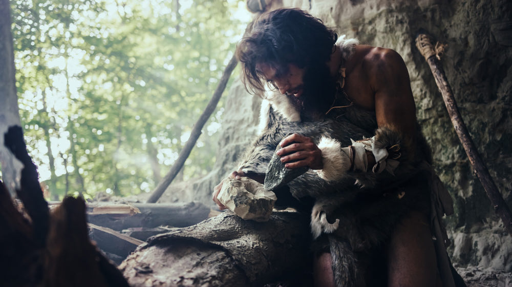 Primeval Caveman Wearing Animal Skin | stone age tools