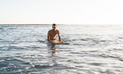 alone-caucasian-surfer-sexy-body-resting | Open Water Survival: Surfing Gone Wrong | The Outside Podcast [LISTEN] | Featured