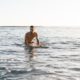 alone-caucasian-surfer-sexy-body-resting | Open Water Survival: Surfing Gone Wrong | The Outside Podcast [LISTEN] | Featured