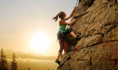 beautiful-woman-climbing-on-high-rock | Women Climbers: Lauren Delaunay Miller's Experience With Rock Climbing [LISTEN] | Featured