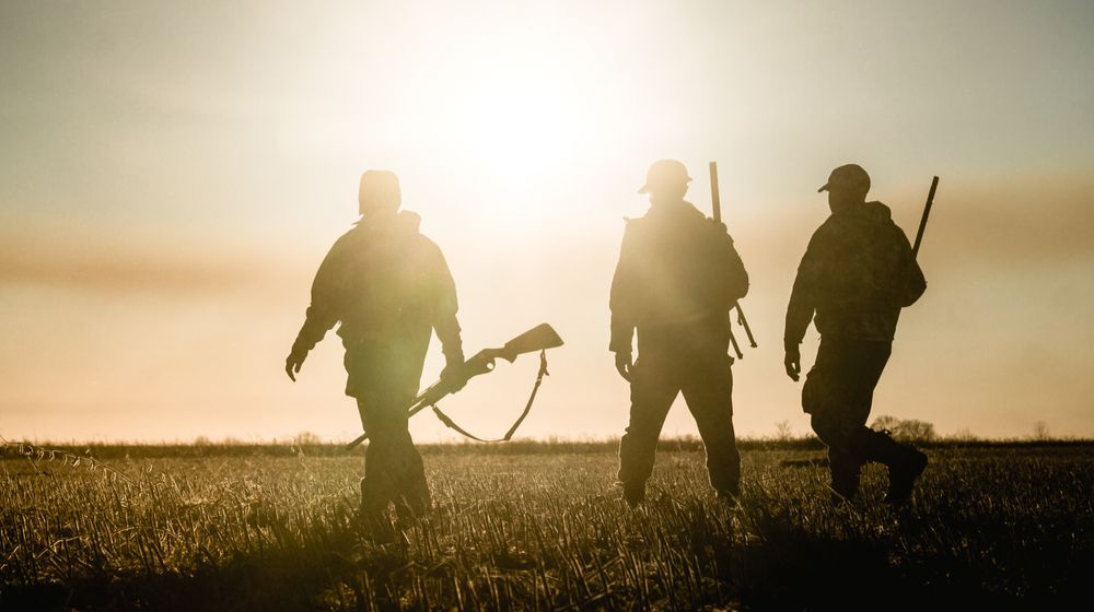 three-hunters-on-background-sunset-field Hunting Club In New Hampshire | Featured