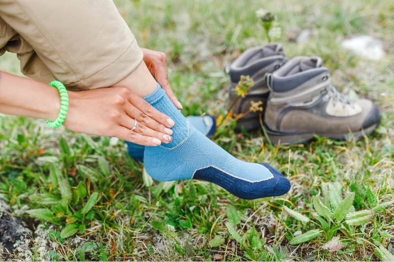 woman puts on high-tech trekking socks for hikes-Boot Accessories-ss